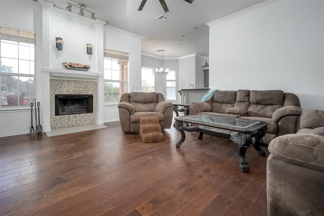 7712 Timber Creek Dr, Choctaw, OK 73020 - living room featuring ceiling fan, ornamental molding, dark wood-type flooring, a fireplace with flush hearth, and a chandelier