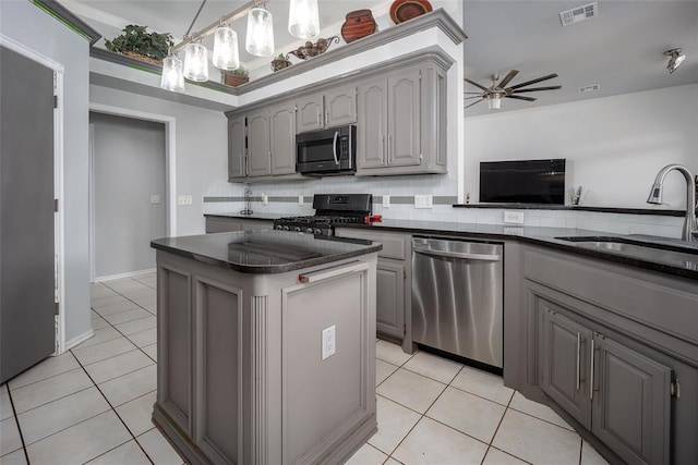 7712 Timber Creek Dr, Choctaw, OK 73020 - kitchen with gray cabinetry, dark countertops, stainless steel appliances, and light tile patterned flooring
