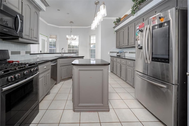 7712 Timber Creek Dr, Choctaw, OK 73020 - kitchen with gray cabinets, appliances with stainless steel finishes, a chandelier, a peninsula, and a kitchen island