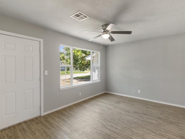 3927 SE 10th Pl, Del City, OK 73115 - spare room featuring ceiling fan, wood finished floors, and a textured ceiling