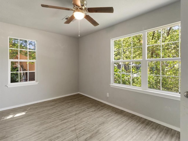 3927 SE 10th Pl, Del City, OK 73115 - empty room with plenty of natural light, wood finished floors, and a ceiling fan