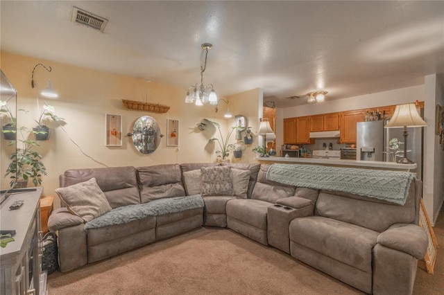 957 N Windermere Dr, Moore, OK 73160 - living area featuring light colored carpet and a chandelier