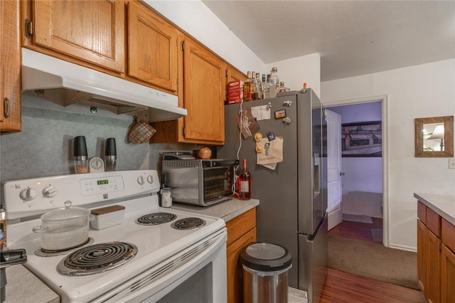 957 N Windermere Dr, Moore, OK 73160 - kitchen featuring white range with electric cooktop, under cabinet range hood, stainless steel fridge with ice dispenser, light countertops, and brown cabinetry