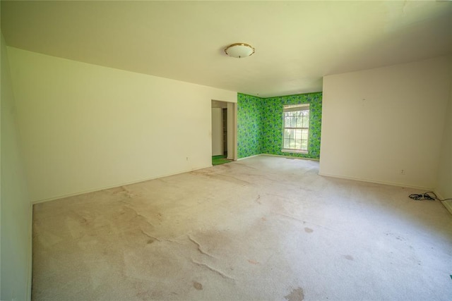 1507 Mill Creek Rd, Edmond, OK 73025 - spare room featuring light colored carpet and baseboards