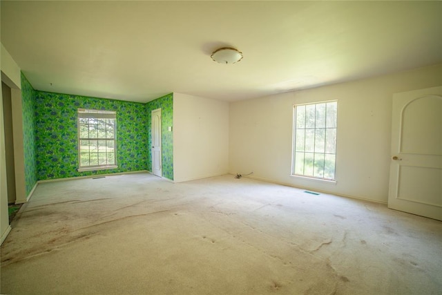 1507 Mill Creek Rd, Edmond, OK 73025 - carpeted empty room featuring plenty of natural light