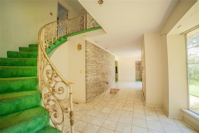 1507 Mill Creek Rd, Edmond, OK 73025 - stairway featuring healthy amount of natural light and brick wall