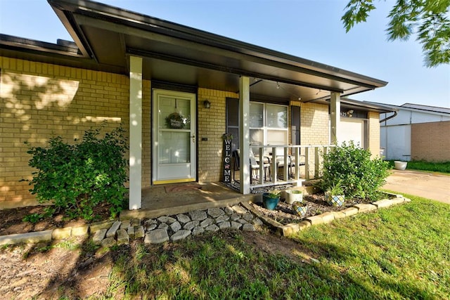 625 N Ramblin Oaks Dr, Moore, OK 73160 - entrance to property featuring brick siding, covered porch, an attached garage, and concrete driveway