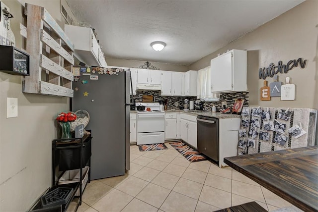 625 N Ramblin Oaks Dr, Moore, OK 73160 - kitchen with appliances with stainless steel finishes, backsplash, white cabinets, light tile patterned floors, and light countertops