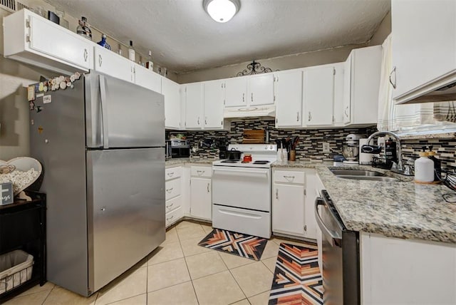 625 N Ramblin Oaks Dr, Moore, OK 73160 - kitchen featuring stainless steel appliances, backsplash, light stone counters, under cabinet range hood, and white cabinetry