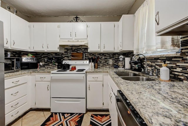 625 N Ramblin Oaks Dr, Moore, OK 73160 - kitchen featuring stainless steel appliances, under cabinet range hood, backsplash, light tile patterned floors, and white cabinetry