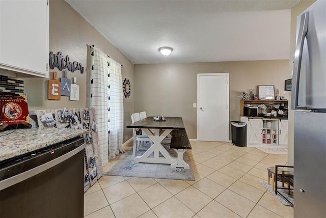 625 N Ramblin Oaks Dr, Moore, OK 73160 - kitchen with freestanding refrigerator, dishwasher, and light tile patterned floors