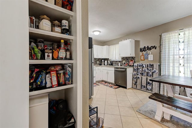 625 N Ramblin Oaks Dr, Moore, OK 73160 - kitchen with dishwasher, white cabinetry, light countertops, light tile patterned floors, and decorative backsplash
