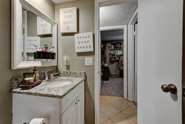 625 N Ramblin Oaks Dr, Moore, OK 73160 - bathroom featuring vanity, tile patterned floors, and a textured wall