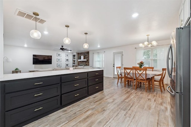 8 Corona Dr, Oklahoma City, OK 73149 - kitchen with freestanding refrigerator, open floor plan, light countertops, light wood-style floors, and recessed lighting