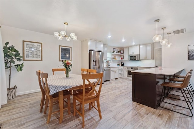 8 Corona Dr, Oklahoma City, OK 73149 - dining space with light wood finished floors, a chandelier, and recessed lighting
