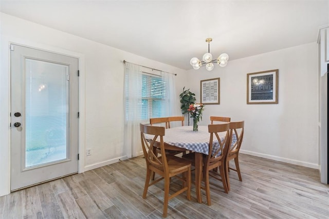 8 Corona Dr, Oklahoma City, OK 73149 - dining space featuring a chandelier and light wood-style flooring