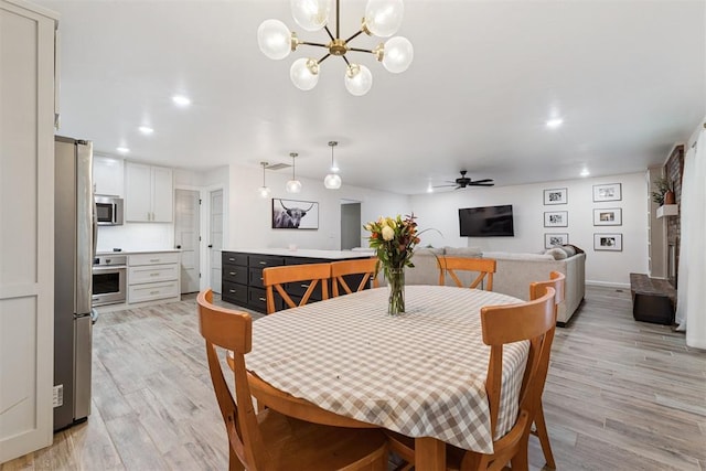 8 Corona Dr, Oklahoma City, OK 73149 - dining room featuring light wood-style flooring, ceiling fan, a chandelier, and recessed lighting