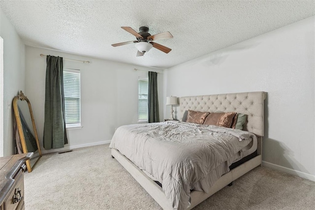 8 Corona Dr, Oklahoma City, OK 73149 - carpeted bedroom featuring a textured ceiling and a ceiling fan