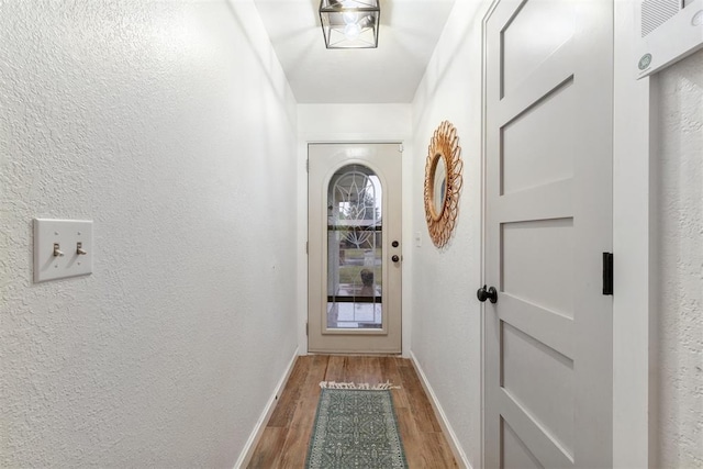 8 Corona Dr, Oklahoma City, OK 73149 - doorway featuring wood finished floors and a textured wall