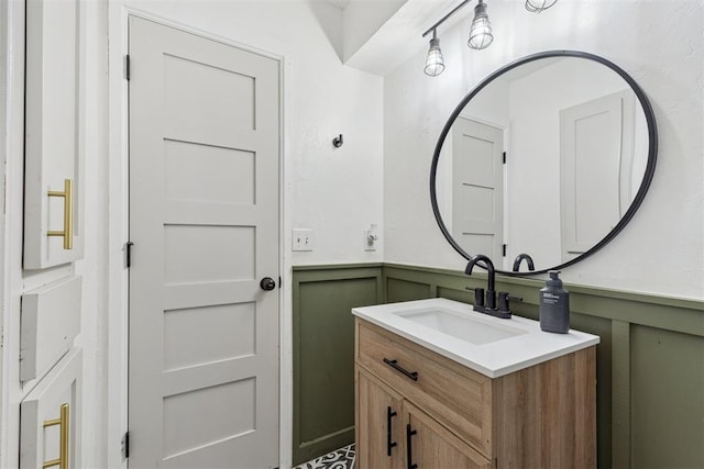 8 Corona Dr, Oklahoma City, OK 73149 - bathroom featuring a decorative wall, vanity, and a wainscoted wall