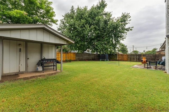 8 Corona Dr, Oklahoma City, OK 73149 - fenced backyard with a patio area and a trampoline