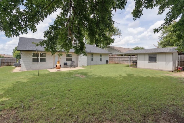 8 Corona Dr, Oklahoma City, OK 73149 - back of property featuring a fenced backyard, roof with shingles, brick siding, and a patio area