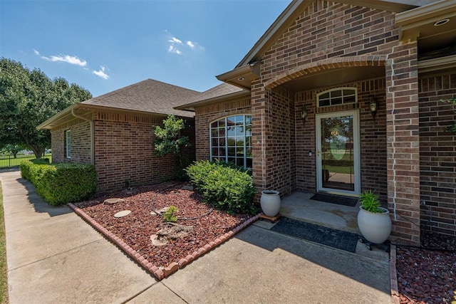 4700 SE 118th St, Oklahoma City, OK 73165 - doorway to property with brick siding and a shingled roof