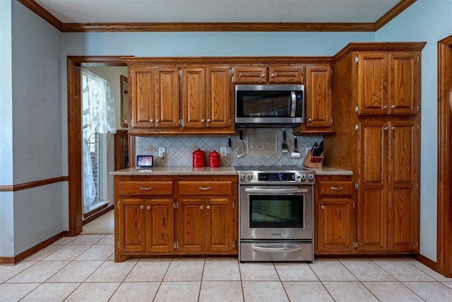 4700 SE 118th St, Oklahoma City, OK 73165 - kitchen featuring appliances with stainless steel finishes, brown cabinetry, decorative backsplash, and crown molding