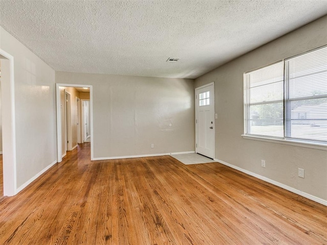 117 Asbill Ave, Yukon, OK 73099 - foyer entrance featuring a textured ceiling and light wood-type flooring