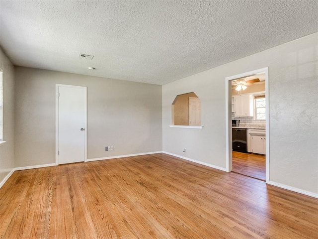 117 Asbill Ave, Yukon, OK 73099 - spare room with light wood-type flooring, a textured ceiling, and a ceiling fan