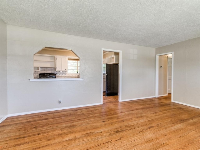 117 Asbill Ave, Yukon, OK 73099 - spare room with light wood-type flooring and a textured ceiling