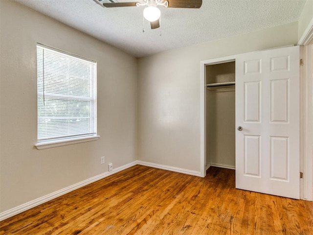 117 Asbill Ave, Yukon, OK 73099 - unfurnished bedroom with wood finished floors, a closet, a textured ceiling, and ceiling fan