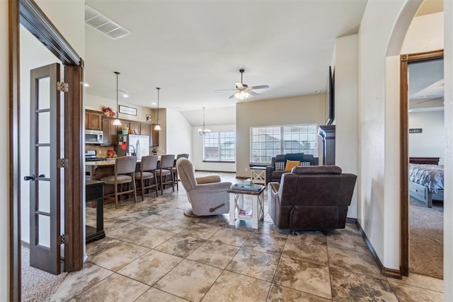 3730 Ruby Rdg, Piedmont, OK 73078 - living area featuring a ceiling fan, arched walkways, and a chandelier
