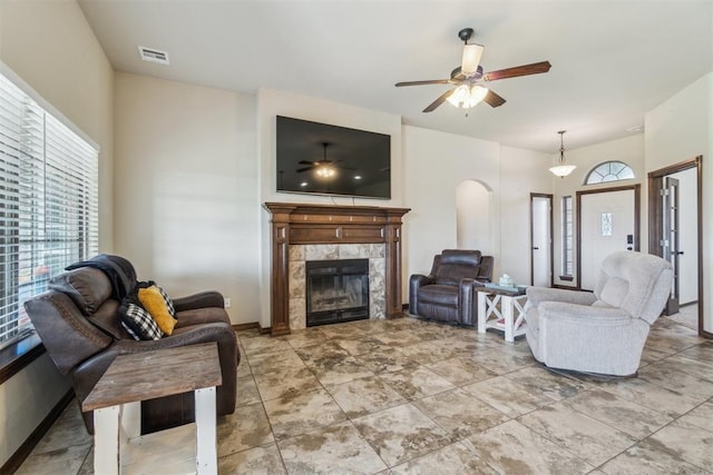 3730 Ruby Rdg, Piedmont, OK 73078 - living area with a tile fireplace, arched walkways, and a ceiling fan
