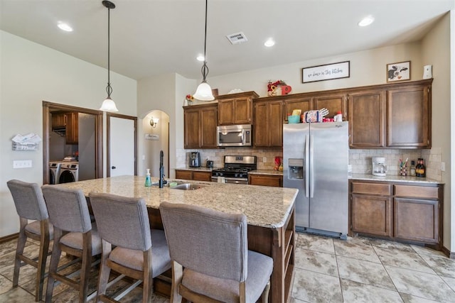 3730 Ruby Rdg, Piedmont, OK 73078 - kitchen with appliances with stainless steel finishes, tasteful backsplash, a center island with sink, a breakfast bar, and recessed lighting
