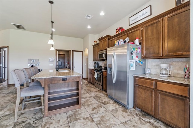 3730 Ruby Rdg, Piedmont, OK 73078 - kitchen with stainless steel appliances, tasteful backsplash, light stone counters, hanging light fixtures, and recessed lighting