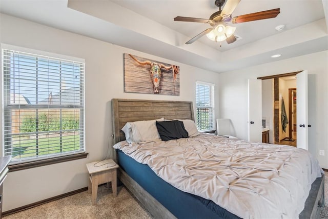 3730 Ruby Rdg, Piedmont, OK 73078 - bedroom featuring a tray ceiling, carpet floors, and a ceiling fan