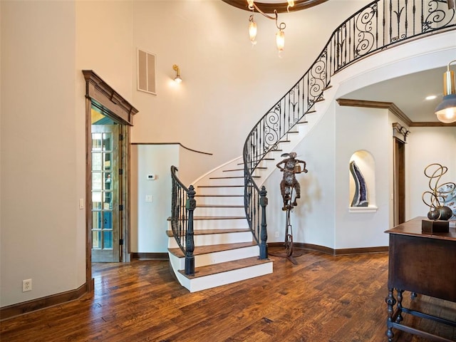 3325 Winding Creek Cir, Edmond, OK 73034 - entrance foyer with a towering ceiling, wood finished floors, stairway, and ornamental molding
