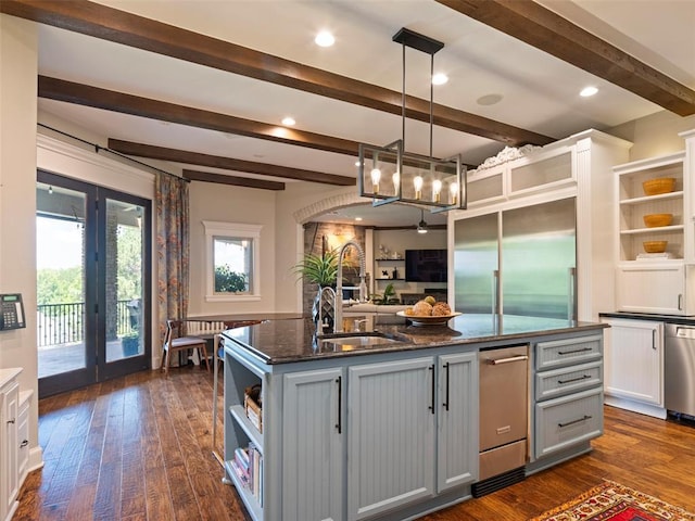 3325 Winding Creek Cir, Edmond, OK 73034 - kitchen with open shelves, gray cabinets, beamed ceiling, a chandelier, and an island with sink