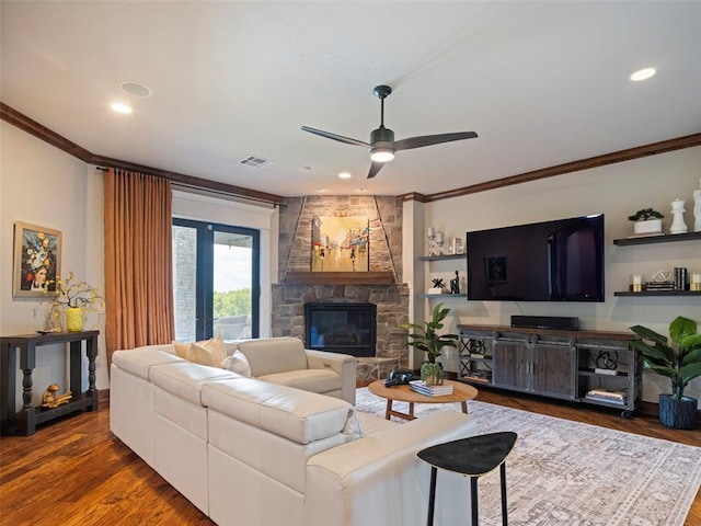 3325 Winding Creek Cir, Edmond, OK 73034 - living area with ornamental molding, a ceiling fan, a stone fireplace, dark wood-style floors, and recessed lighting