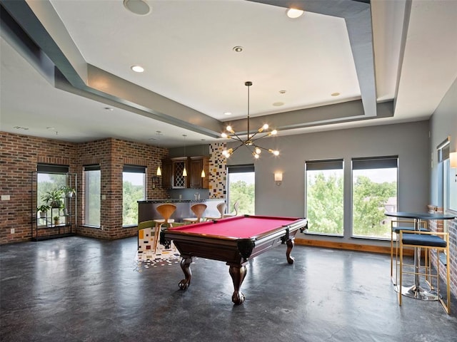 3325 Winding Creek Cir, Edmond, OK 73034 - game room with a tray ceiling, concrete flooring, brick wall, pool table, and recessed lighting