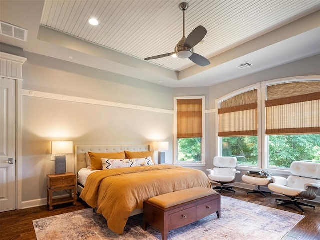 3325 Winding Creek Cir, Edmond, OK 73034 - bedroom with a tray ceiling, wood-type flooring, multiple windows, a ceiling fan, and wood ceiling