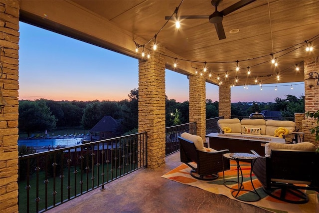 3325 Winding Creek Cir, Edmond, OK 73034 - patio terrace at dusk featuring a balcony, an outdoor living space with a fire pit, and ceiling fan