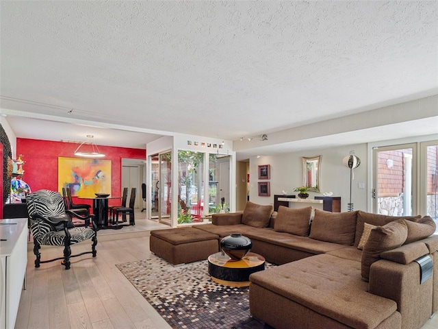 7501 Brookside Dr, Oklahoma City, OK 73132 - living area featuring a textured ceiling and light wood-style flooring