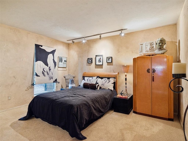 7501 Brookside Dr, Oklahoma City, OK 73132 - carpeted bedroom featuring track lighting and a textured wall