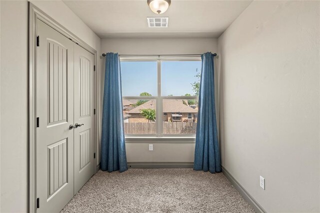 2828 Ryder Dr, Yukon, OK 73099 - unfurnished bedroom with carpet, multiple windows, and a closet