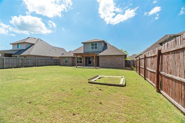 2828 Ryder Dr, Yukon, OK 73099 - back of house with a fenced backyard, brick siding, a pergola, and a shingled roof