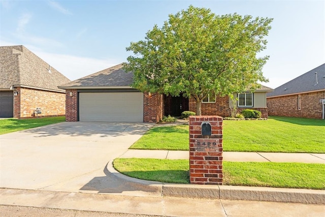 2429 NW 176th St, Edmond, OK 73012 - view of front of home featuring a garage, a front lawn, concrete driveway, and brick siding