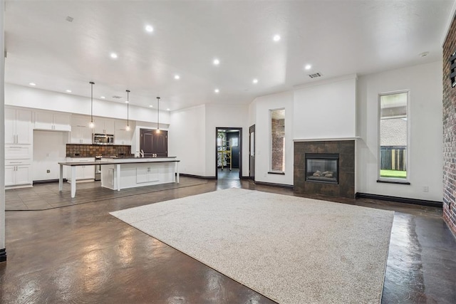 2429 NW 176th St, Edmond, OK 73012 - unfurnished living room featuring recessed lighting, finished concrete floors, and a fireplace