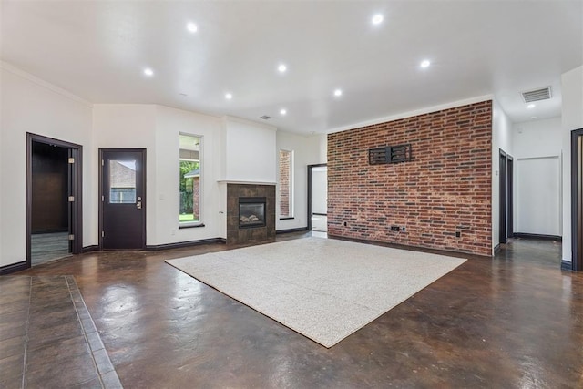 2429 NW 176th St, Edmond, OK 73012 - unfurnished living room featuring finished concrete flooring, a tile fireplace, recessed lighting, and brick wall